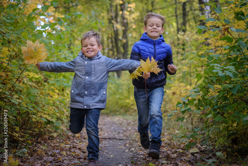 two happy boys run through the autumn Park © androsov858
