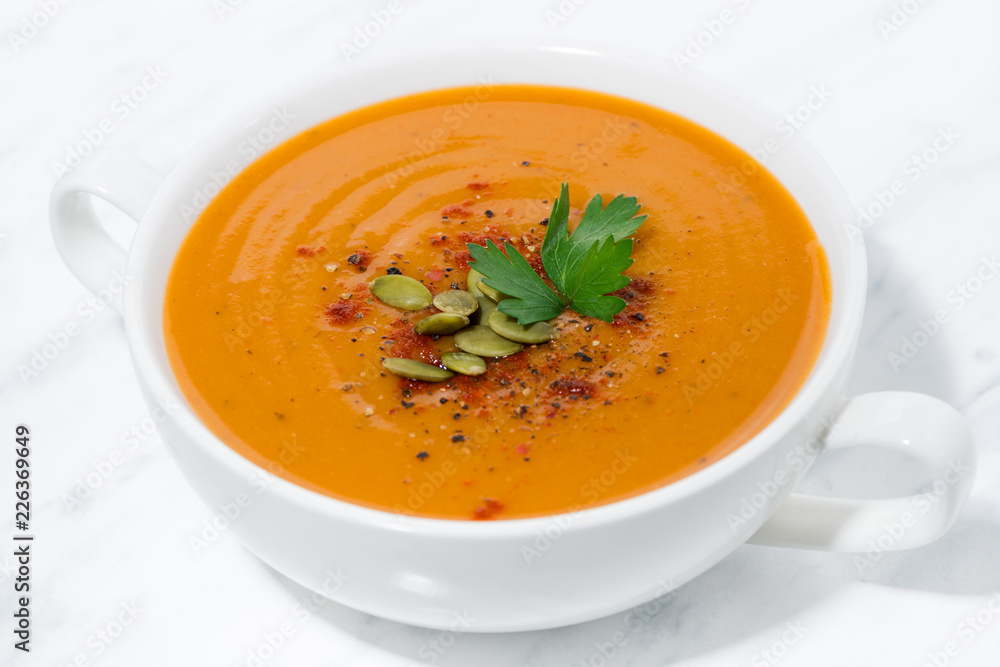 soup of pumpkin and lentils on white background, closeup soup of pumpkin and lentils on white background, closeup