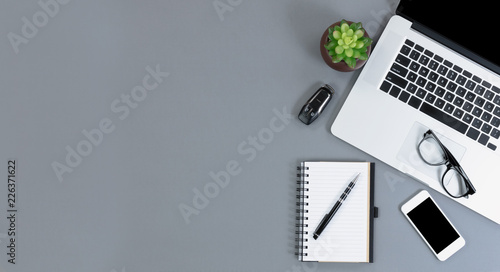 Flat lay view of gray desk with amply copy space for telework or telecommute concept photo