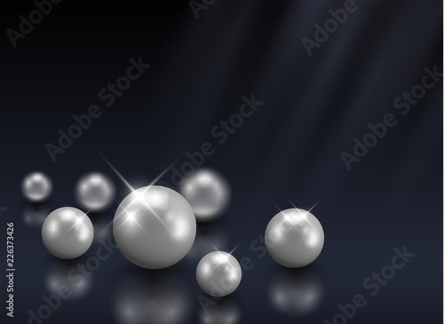 Group of beautiful vector shining pearls on dark blue background with blurred light beams - luxury, beauty concept