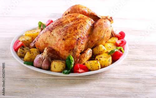 Whole roast spicy chicken with potatoes