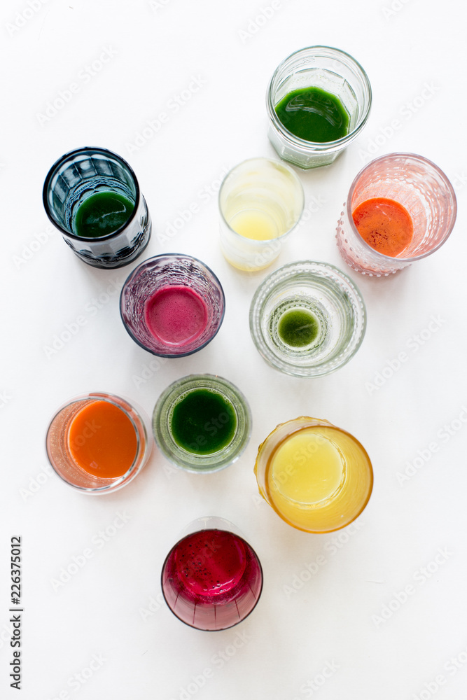 cups of freshly pressed juice on white background cups of freshly pressed juice on white background
