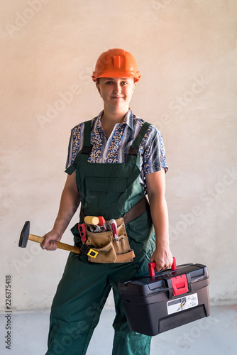 Female worker with tool kit and gavel photo