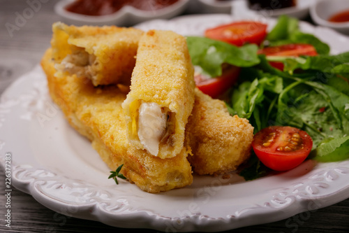 Fish sticks fried in breadcrumbs on a plate
