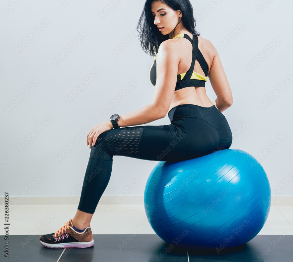 Young fitness woman with blue fitball. Crossfit training. Young fitness woman with blue fitball. Crossfit training.