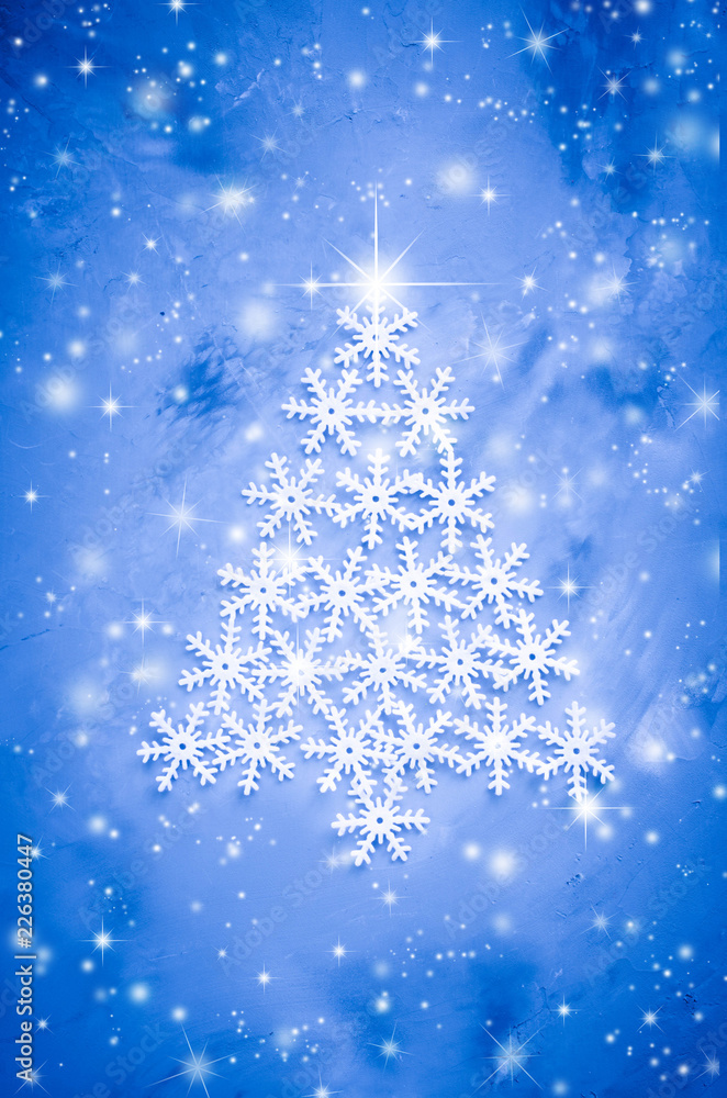Decorative snowflakers laid in the form of a Christmas tree on a gray background. Decorative snowflakers laid in the form of a Christmas tree on a gray background.
