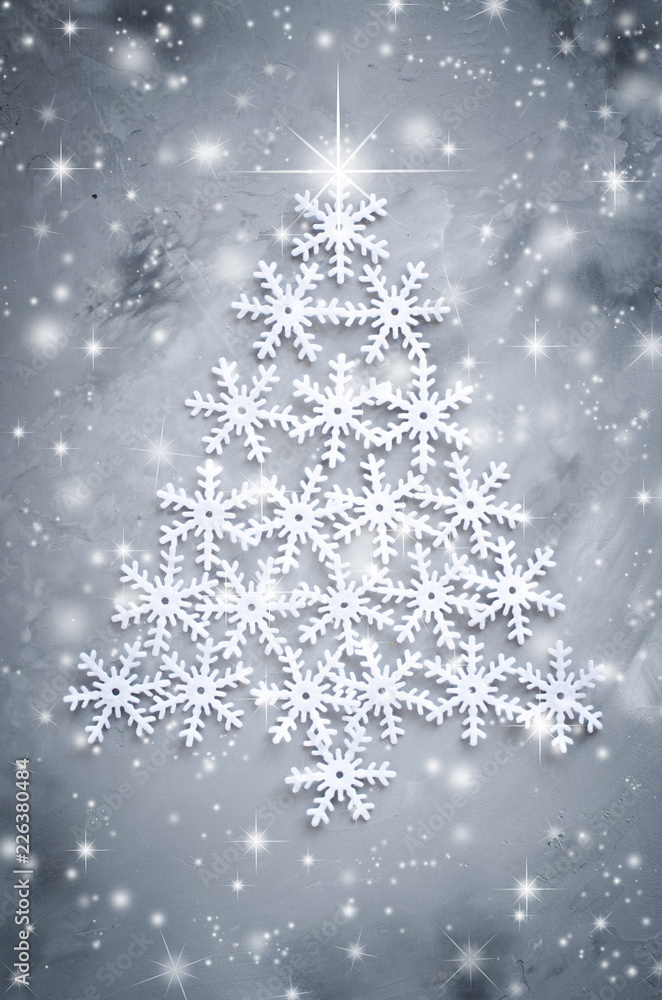 Decorative snowflakers laid in the form of a Christmas tree on a gray background. Decorative snowflakers laid in the form of a Christmas tree on a gray background.