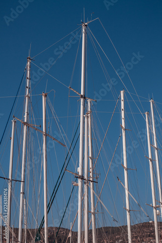 Poles of Sailing Yachts Against Blue Sky Background