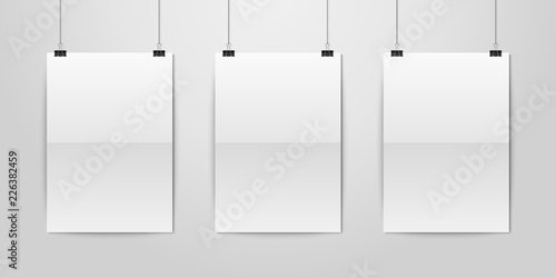 Three Vector Realistic White Blank Vertical A4 Folded Paper Poster Hanging on a Rope with Binder Clip Set on White Wall mock-up. Empty Poster Design Template for Graphics, Mockup © gomolach