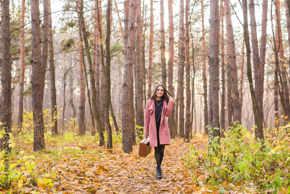 Fall, season and people concept - young woman walking in park at autumn Fall, season and people concept - young woman walking in park at autumn