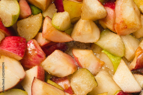 Ripe apples and pears cooked in sugar syrup. Process of making jam marmalade at home.