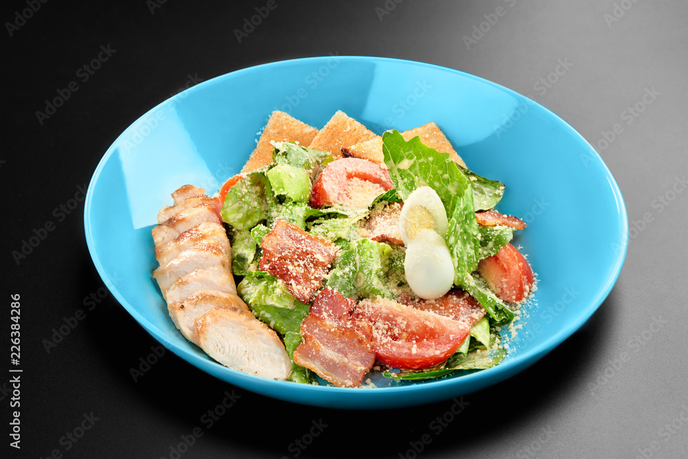 Salad tomatoes leaves chicken breast bacon eggs basil Concept healthy meal black background menu restaurant Salad tomatoes leaves chicken breast bacon eggs basil Concept healthy meal black background menu restaurant