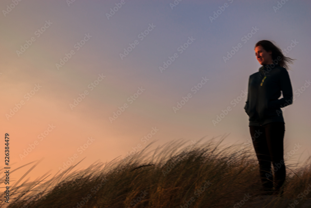 Peaceful girl enjoying a sunset on the beach Peaceful girl enjoying a sunset on the beach