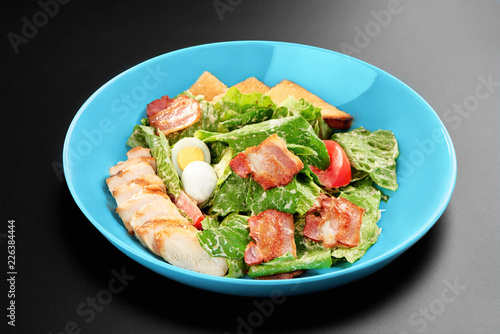 Salad tomatoes leaves chicken breast bacon eggs basil Concept healthy meal black background menu restaurant