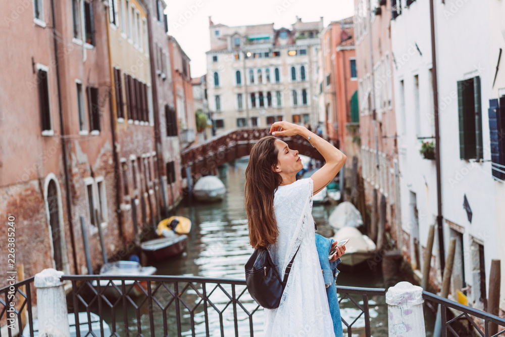 Fototapeta premium young girl walks the streets of Venice