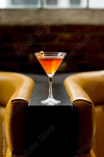orange cocktail with lemon twist 
