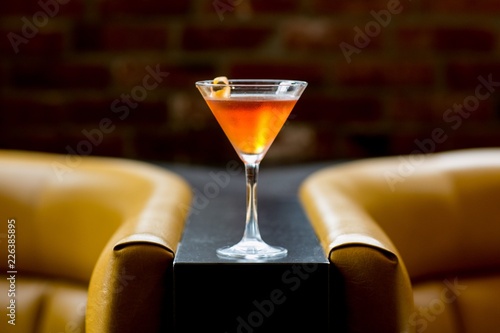 orange cocktail with lemon twist 