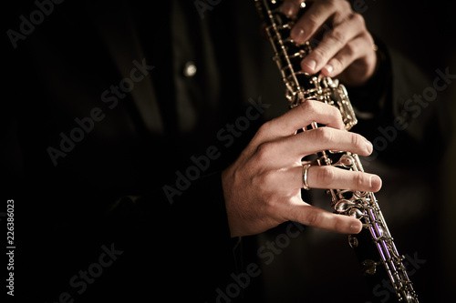 Oboe player on dark background musician