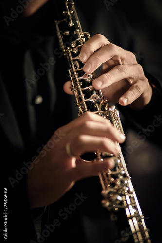 Oboe player on dark background musician photo