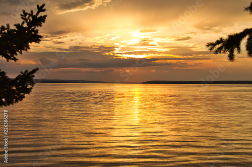 The sun setting over Waskesiu Lake in Prince Albert National Park of Canada. photo