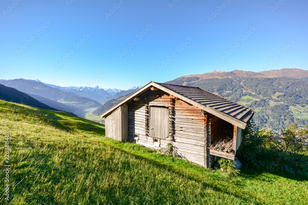 Alpine pasture hike to an old wooden barn with mountain meadow in the austrian alps, Zillertal Austria