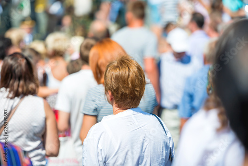 Woman in crowd of people on city street