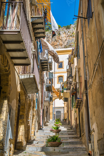 Fototapeta Naklejka Na Ścianę i Meble -  A cozy street in Cefalù on a sunny summer day. Sicily, southern Italy.