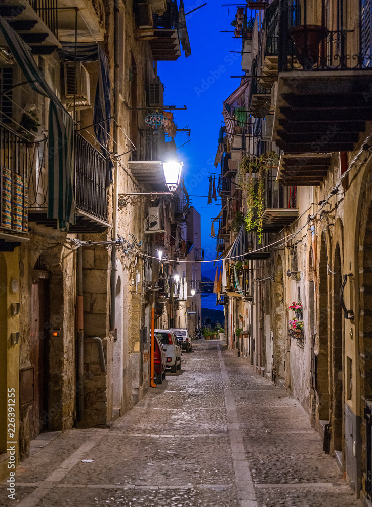 A cozy street in Cefalù in the evening. Sicily, southern Italy.
