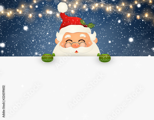 Happy smiling Santa Claus standing behind a blank sign, showing on big blank sign. Cartoon Santa Claus character with white copy space. Christmas background with Falling Christmas snow, light.
