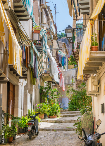 Fototapeta Naklejka Na Ścianę i Meble -  A cozy street in Cefalù on a sunny summer day. Sicily, southern Italy.
