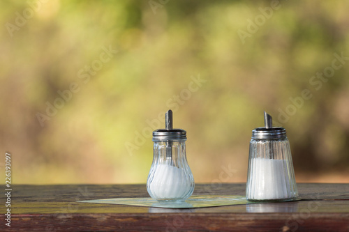 Obraz na plátně Sugar dispenser on a bistro table outdoors