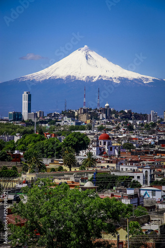 Vista aérea de la ciudad de Puebla con el volcan popocatepetl photo
