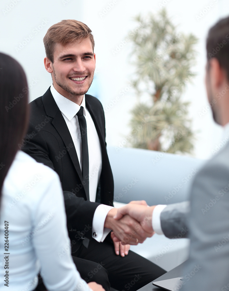handshake business partners in the lobby of the office. handshake business partners in the lobby of the office.