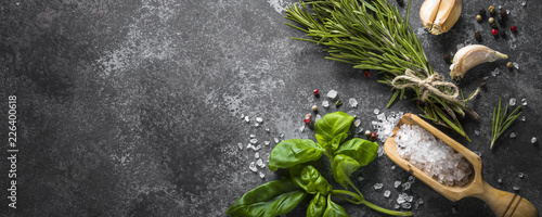 Spices and herbs over black stone table.  © nadianb