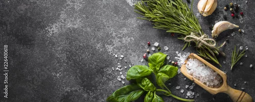 Panel kuchenny z motywem Spices and herbs over black stone table. 