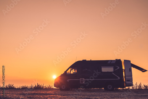 Camper car on nature at sunrise
