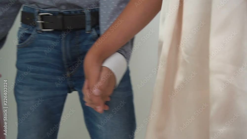 Group of unrecognizable children standing and holding other kids hands. Isolated on white Group of unrecognizable children standing and holding other kids hands. Isolated on white