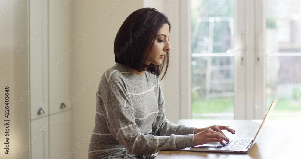 4K Portrait beautiful Asian woman using laptop & turning to smile at camera. Slow motion. 4K Portrait beautiful Asian woman using laptop & turning to smile at camera. Slow motion.