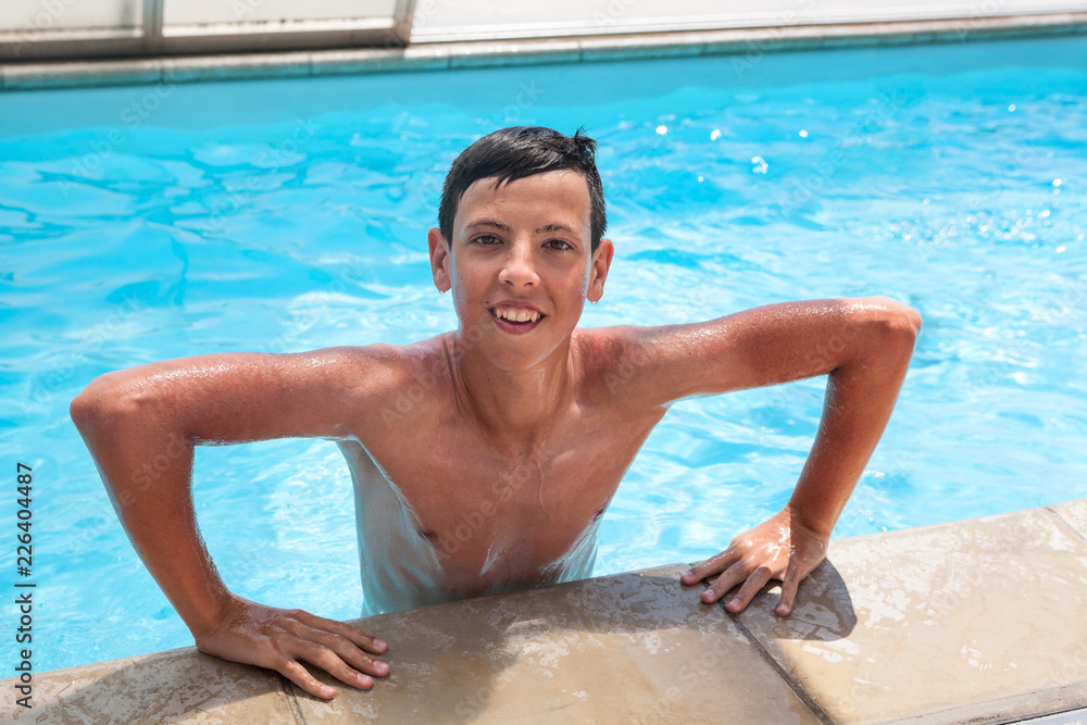 Summertime and swimming activities for happy boy on pool Stock Photo