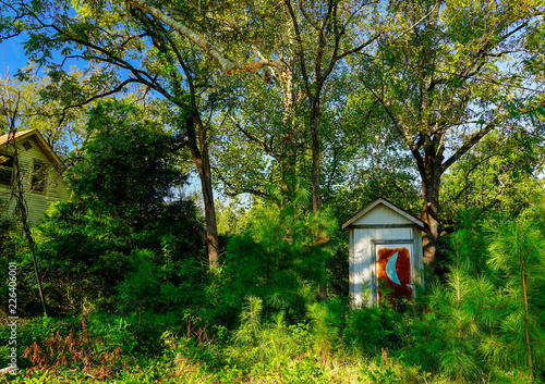 An old moon outhouse surrounded by trees in North Carolina. © Mark Alan Howard