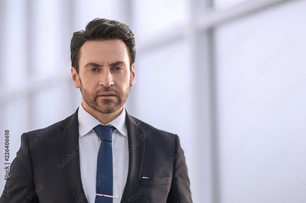serious businessman on the background of the office window serious businessman on the background of the office window
