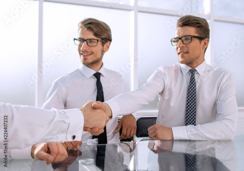 handshakes of business people in a modern office