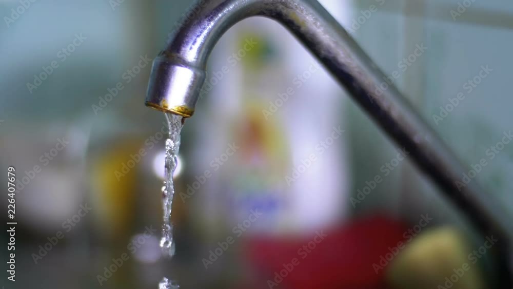 Water Running from the Tap into a Sink. Closeup. Slow Motion in 180