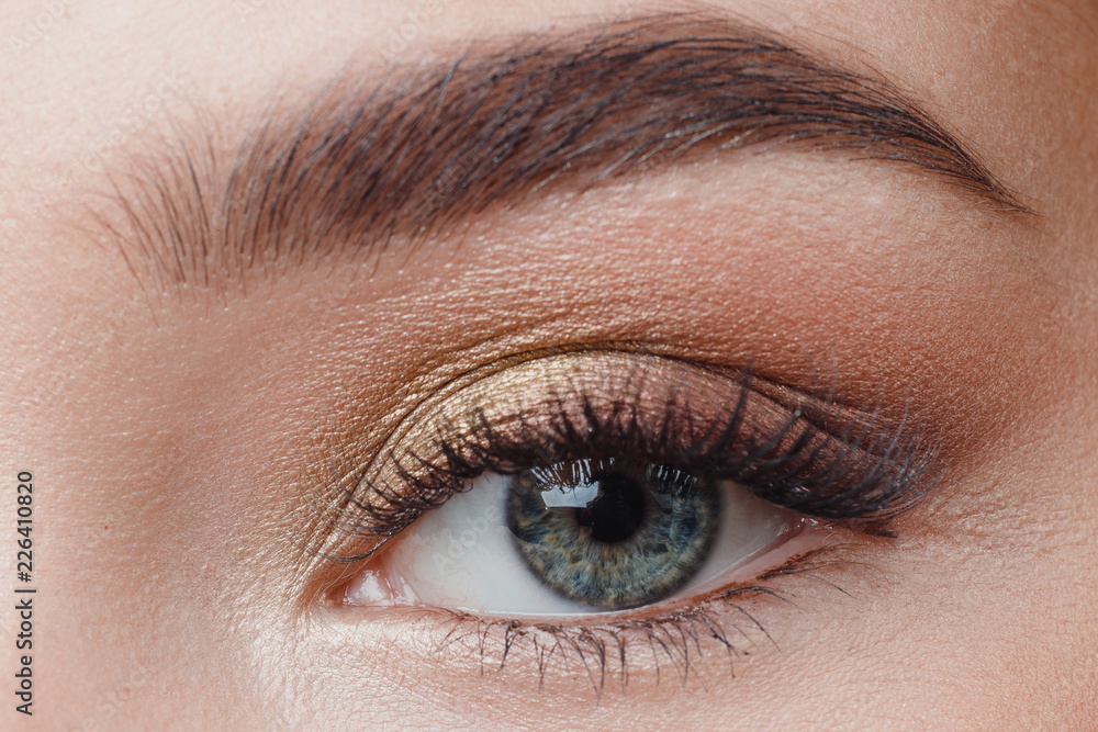 Fototapeta premium Eyelash extension procedure. Beautiful female eyes with long lashes, closeup