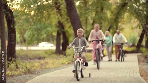 Wallpaper Mural Authentic happy family resting in a Park with a baby boy on the bike. early autumn in the Park lifestyle. Family holidays on bikes Torontodigital.ca