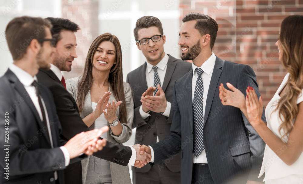 smiling business people shaking hands with each other smiling business people shaking hands with each other