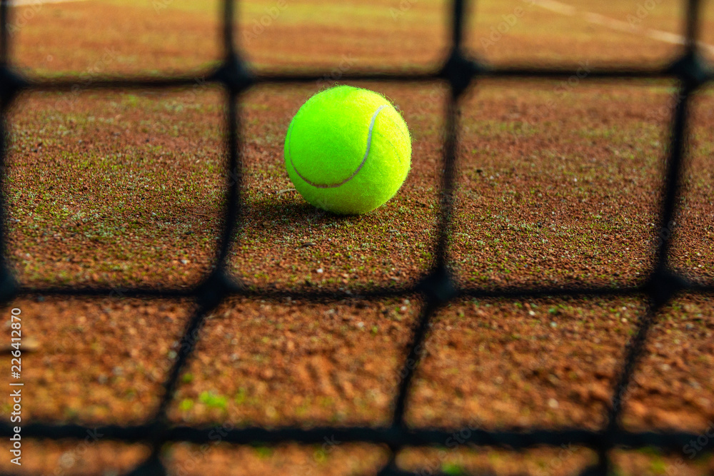 close-up tennis ball and net on court