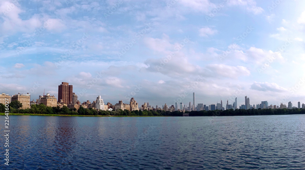Jacqueline Kennedy Onassis Reservoir beautiful clear sunny day with blue sky and clouds and Manhattan skyline