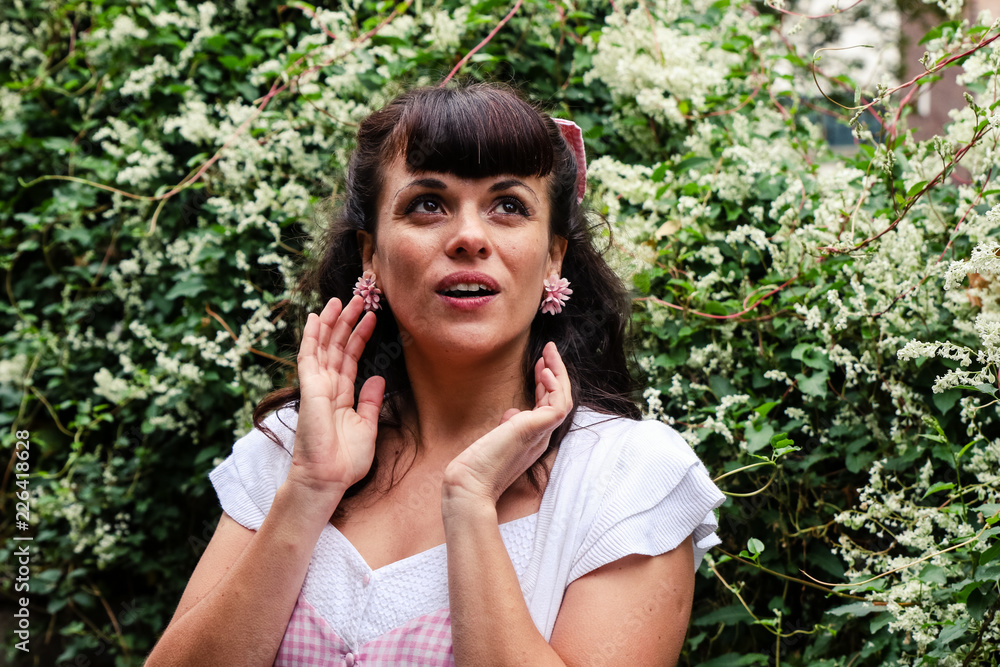 Girl looking to the sky in a parki with flowers dress with vintage clothes