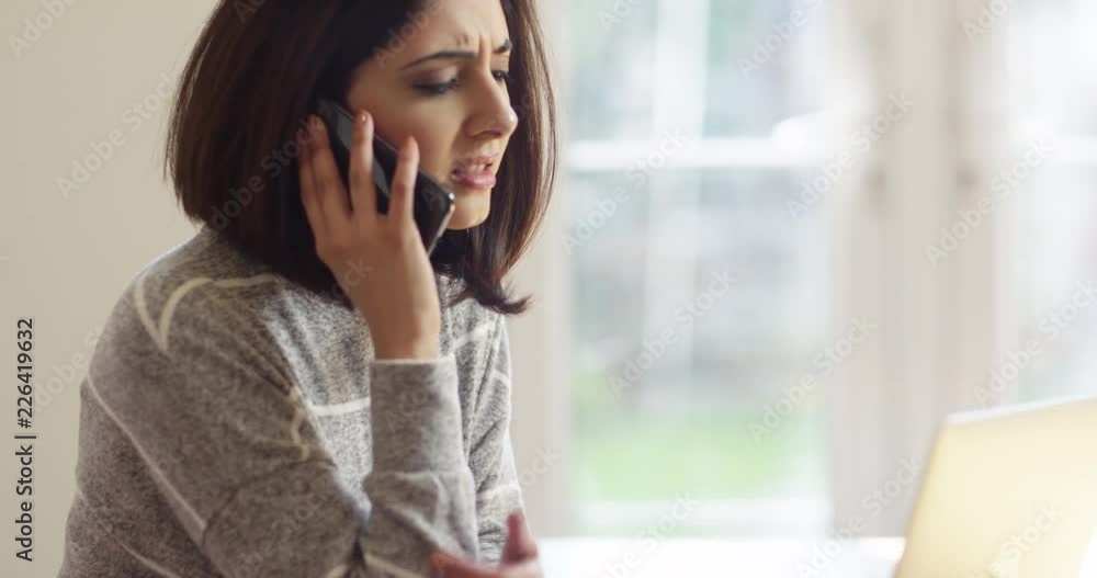 4K Unhappy Asian businesswoman in sunny office dealing with a problem over the phone. Slow motion. 4K Unhappy Asian businesswoman in sunny office dealing with a problem over the phone. Slow motion.